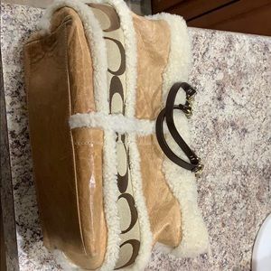 Coach whiskey leather with shearling trim.